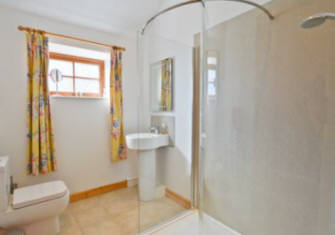 The double bedded room has en suite shower, w.c., and handbasin.  Curlew Cottage  self catering holiday cottage accommodation  North Pennines near Hexham and Hadrian's Wall Northumberland uk